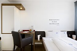 Bright and cozy double room with desk – comfortable hotelroom at Lake Constance.